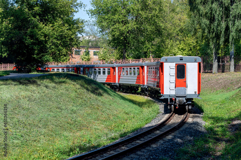 The train departs around the bend. Russian children's railway in Novomoskovsk in August 2021. The train departs around the bend. Russian children's railway in Novomoskovsk in August 2021.