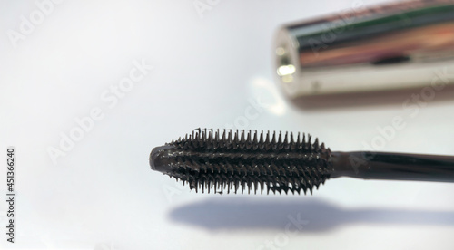 Close-up of mascara brush on white background. Beauty concept
