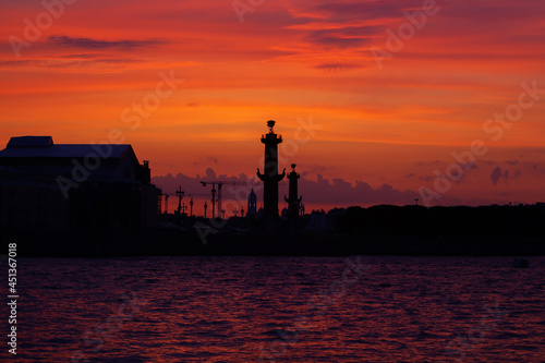 Sunset on the Neva River in Saint Petersburg. View of the rostral columns. Sunset in St. Petersburg.
