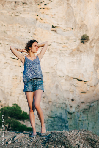 happy traveler girl enjoys freedom on top of mountain © alexkoral