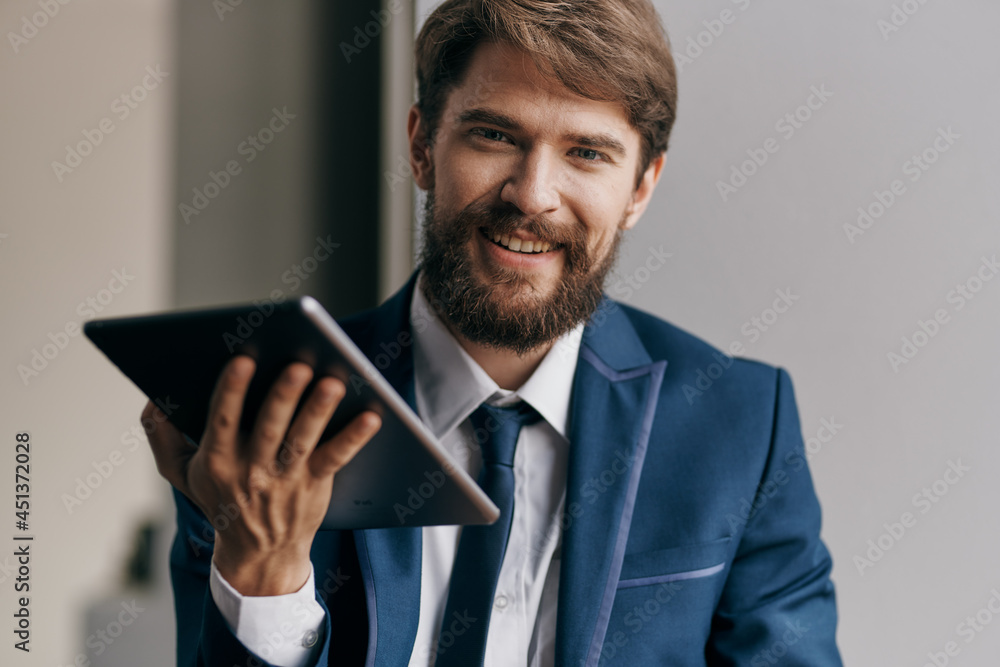 Cheerful business man tablet in hands communicating work Cheerful business man tablet in hands communicating work