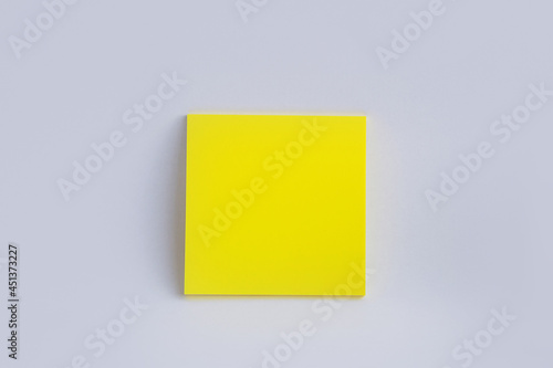 yellow sticky note on white background. Color paper note. Back to school minimal concept