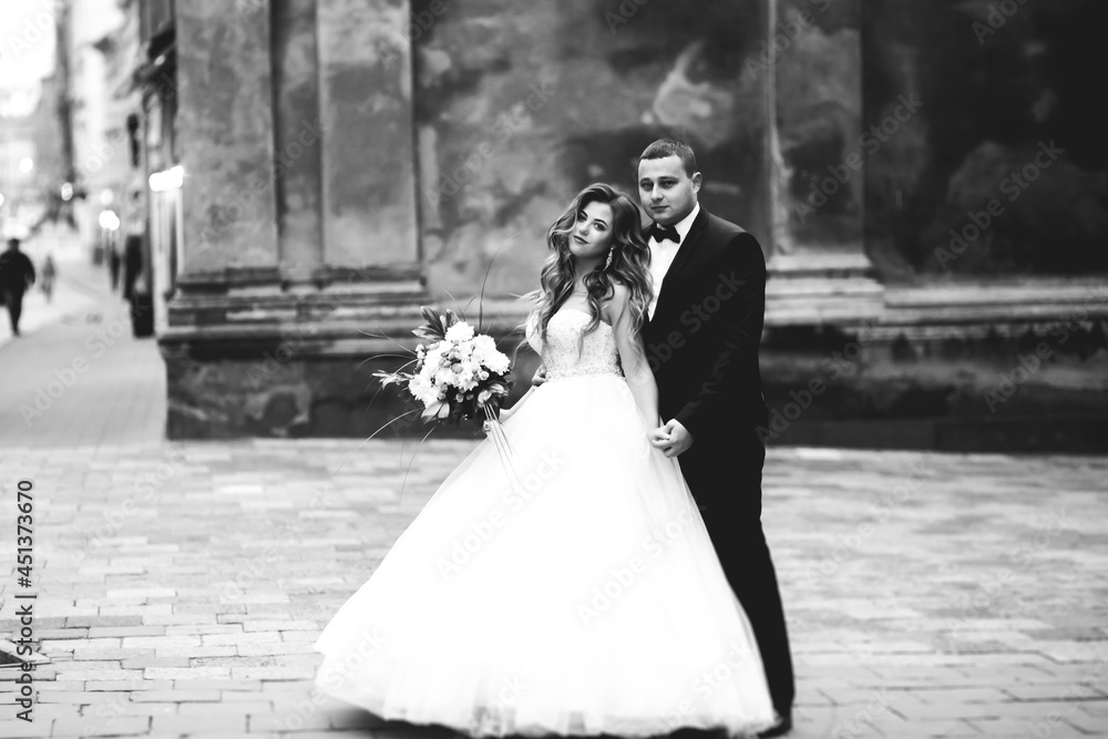 Perfect couple bride, groom posing and kissing in their wedding day Perfect couple bride, groom posing and kissing in their wedding day