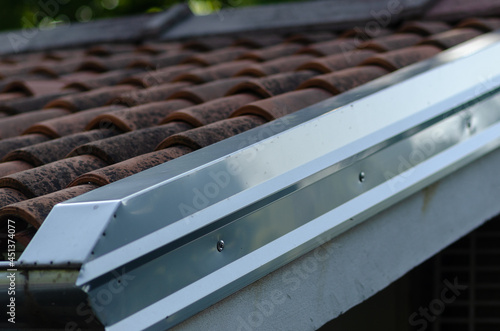 Tablou pe pânză Building: cornice with galvanized steel sheet, detail of the house on the part of the double-sided roof with ridge tiles