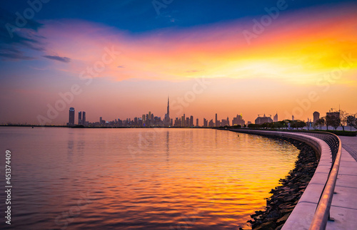 Stunning view of Dubai city skyline at sunset with a colorful sky and reflection on the water. Al Jaddaf, Dubai, UAE. photo
