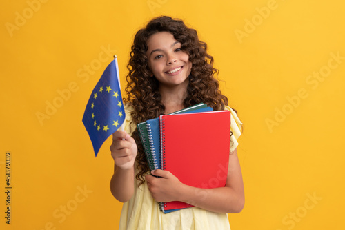 happy teen girl study with school workbooks hold european union flag, schengen visa photo