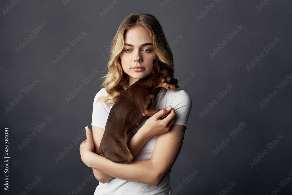 Fototapeta premium woman with a small dog makeup posing dark background