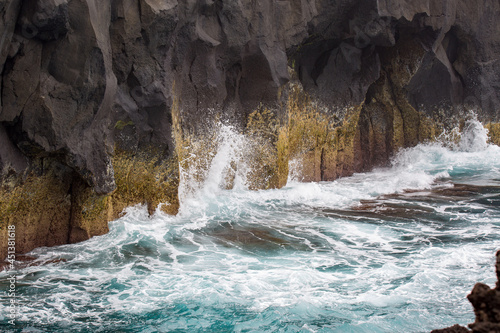 Sea crashing into rocks. Scene from a vulcanic landscape in the Azores