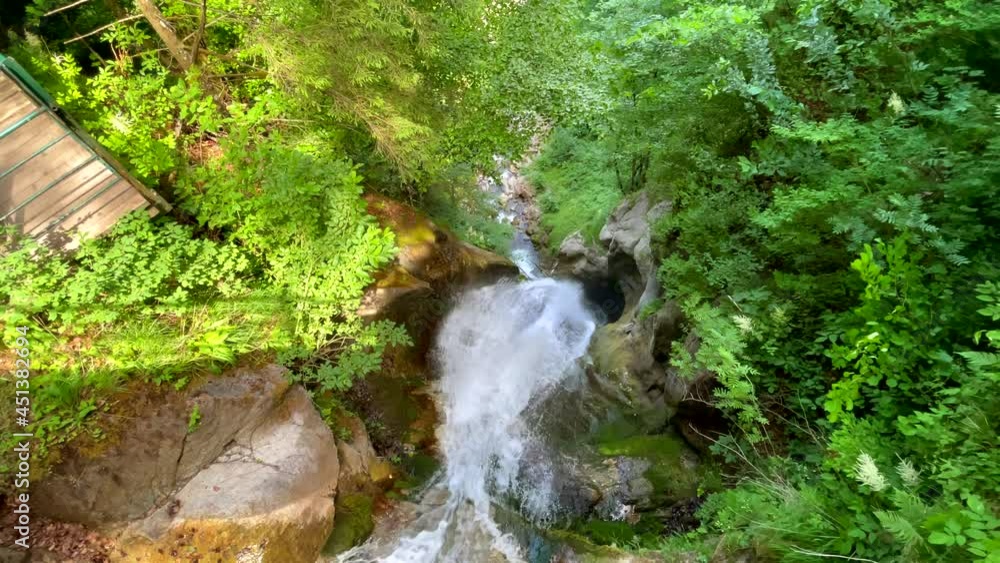 Slow motion top down of crashing idyllic waterfall between green mountains,4K Slow motion top down of crashing idyllic waterfall between green mountains,4K