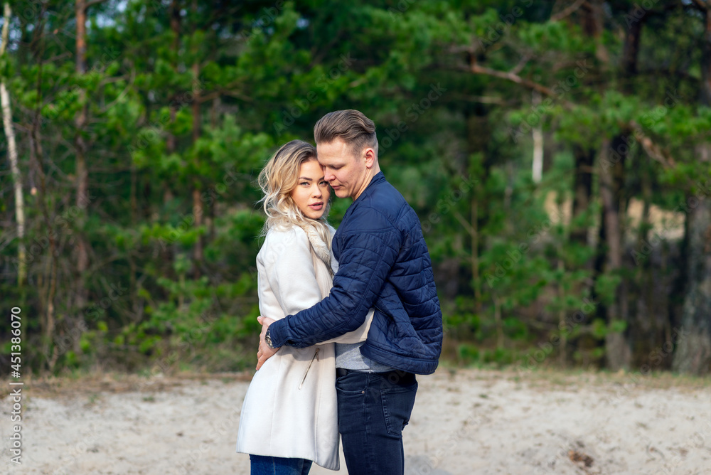 Happy loving couple enjoying of happiness love and tenderness, dating, romance.Couple hugging in love at spring park. Happy loving couple enjoying of happiness love and tenderness, dating, romance.Couple hugging in love at spring park.