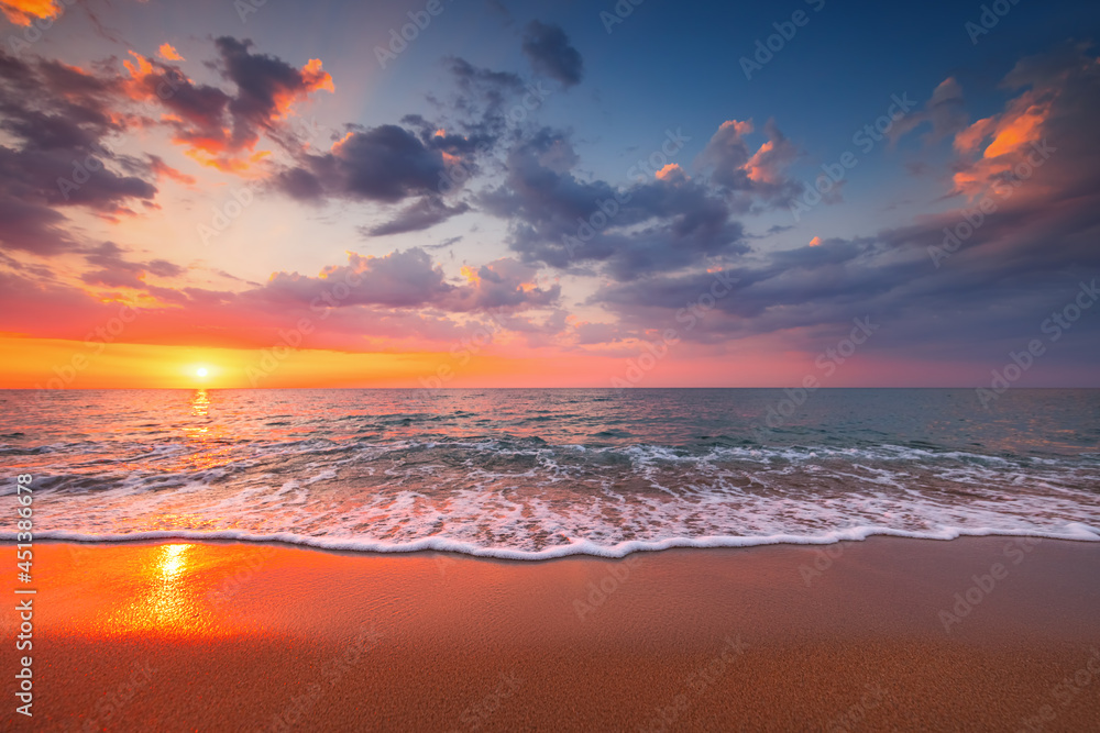 Beautiful cloudscape over the beach and sea at sunrise