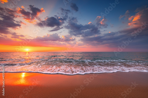 Beautiful cloudscape over the beach and sea at sunrise