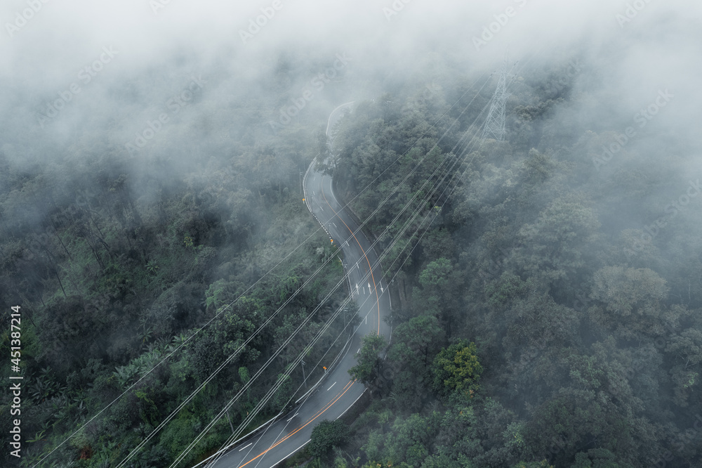 Mountain road in rainy and foggy day