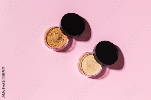 Mineral powder foundation isolated on a pink background. Eco-friendly and organic beauty products