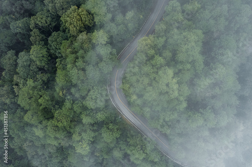 Mountain road in rainy and foggy day