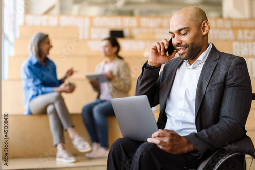 Afro american man manager in wheelchair working