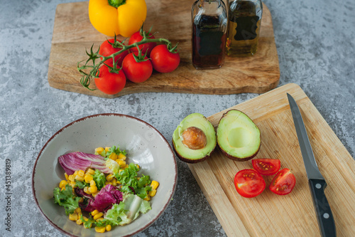 Healthy food. Avocado  cherry tomatoes  bell peppers  corn.