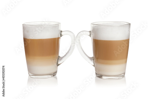 Hot coffee with milk in glass cups isolated on white