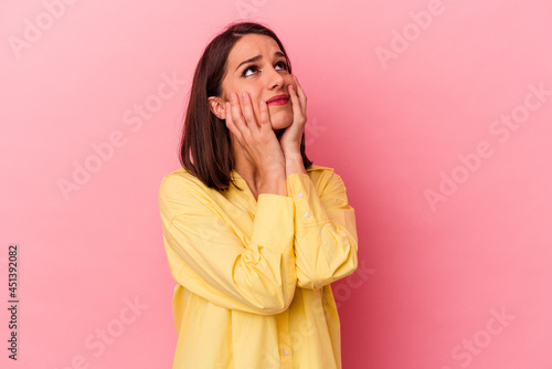Young caucasian woman isolated on pink background whining and crying disconsolately.
