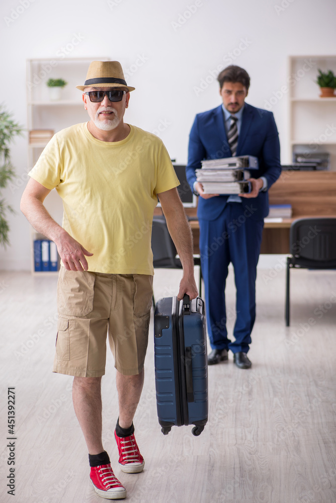 Fototapeta premium Old boss and young male employee in summer vacation concept