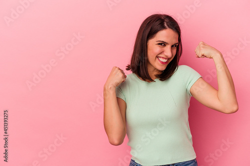 Fototapeta Naklejka Na Ścianę i Meble -  Young caucasian woman isolated on pink background raising fist after a victory, winner concept.