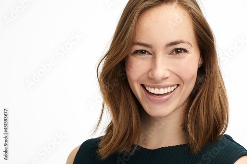 Portrait of a young laughing brunette with a big smile