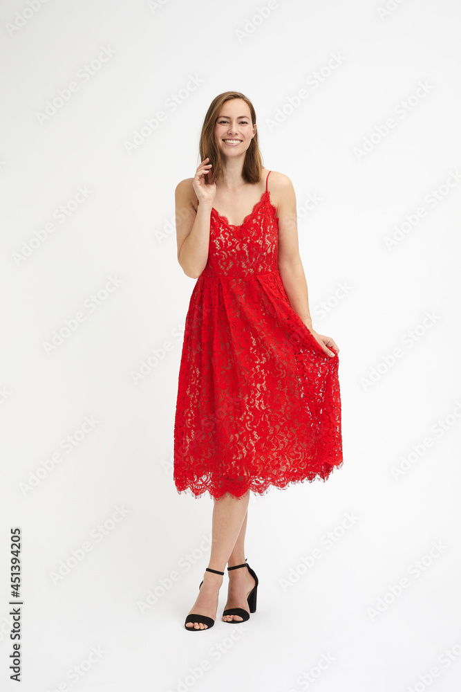 Beautiful portrait of a happy young woman in red dress dancing isolated in white background Beautiful portrait of a happy young woman in red dress dancing isolated in white background