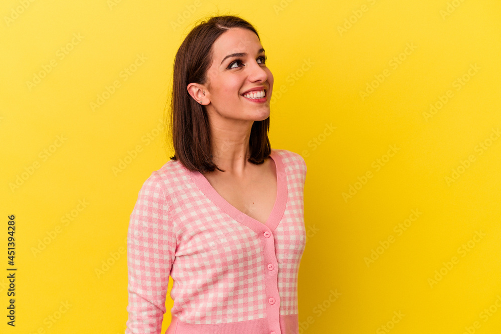 Young caucasian woman isolated on yellow background relaxed and happy laughing, neck stretched showing teeth. Young caucasian woman isolated on yellow background relaxed and happy laughing, neck stretched showing teeth.