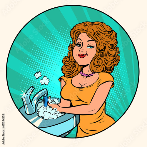 beautiful young woman washes dishes, homework in the kitchen