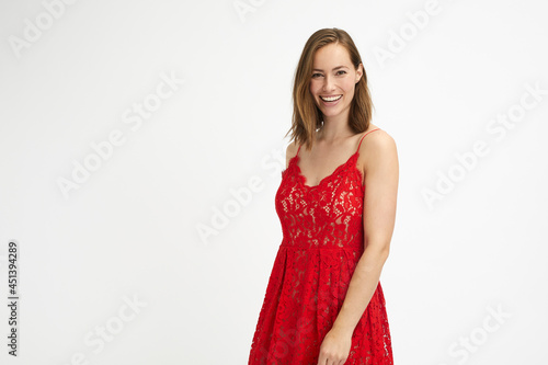 Portrait of a woman in red dress being hoppy while looking in camera