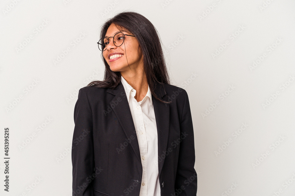 Young business latin woman isolated on white background looks aside smiling, cheerful and pleasant. Young business latin woman isolated on white background looks aside smiling, cheerful and pleasant.