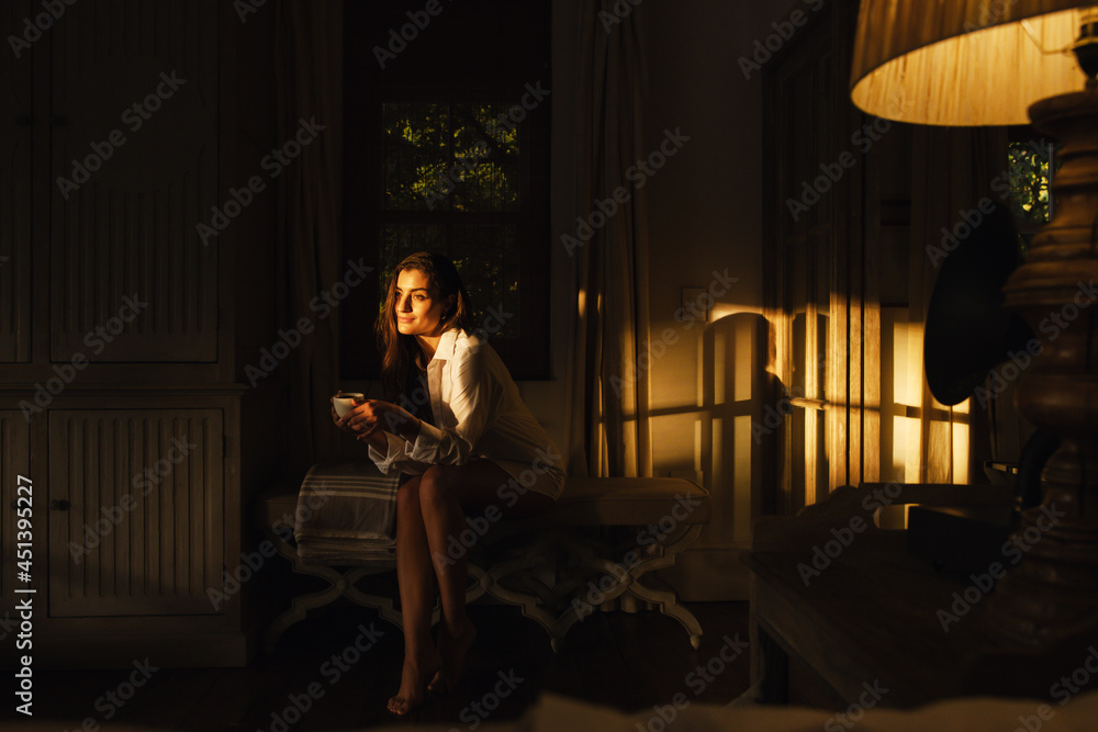 Tourist woman relaxing in a dark hotel room Tourist woman relaxing in a dark hotel room