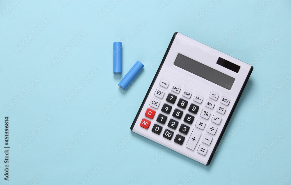 CAlculator with aa batteries on blue background. Top view CAlculator with aa batteries on blue background. Top view