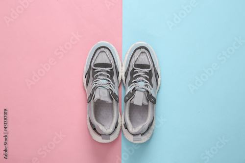 Sports sneakers on a blue-pink pastel background. Running shoes. Pastel color trend