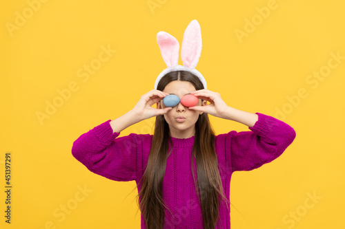 cute teen child in bunny ears holding colorful easter eggs, easter egg