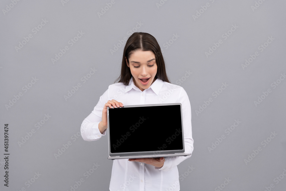 surprised woman in white shirt showing computer ad presentation, copy space, advert surprised woman in white shirt showing computer ad presentation, copy space, advert