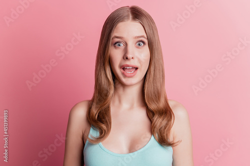 Portrait of shocked funny cute adorable lady open mouth beaming smile on pink background