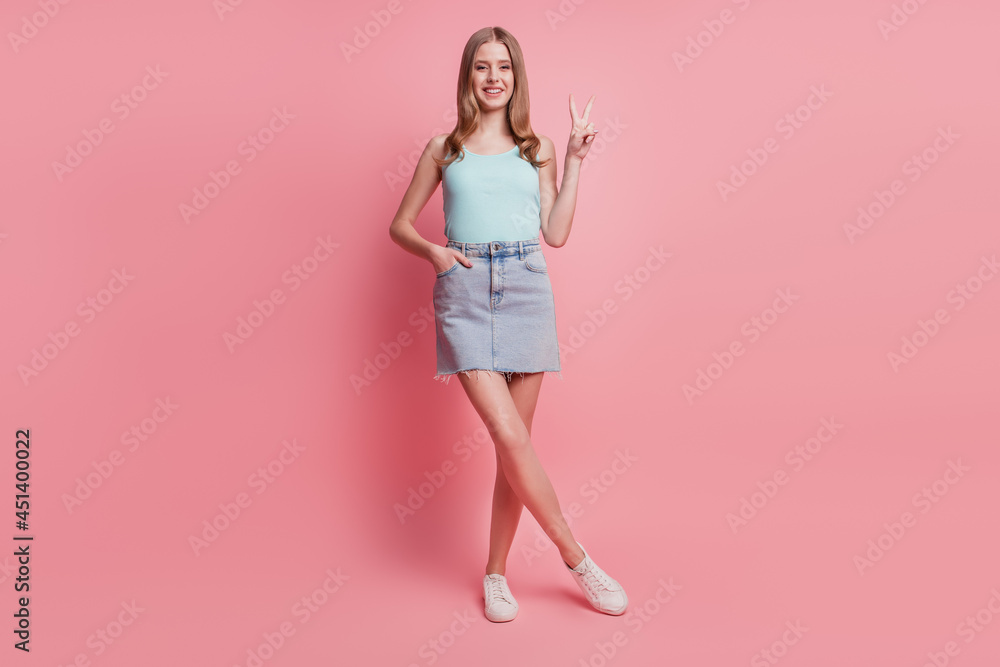 Portrait of lovely friendly positive lady hands show v-sign on pink background