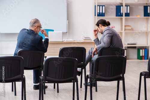 Two businessmen in the classroom in pandemic concept