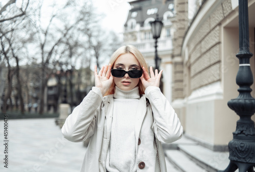 Portrait of fashion woman in trendy stylish sunglasses in the city