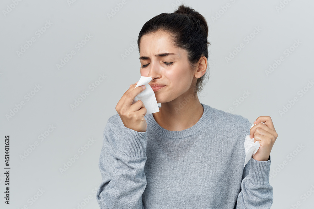 woman with handkerchief runny nose cold infection woman with handkerchief runny nose cold infection