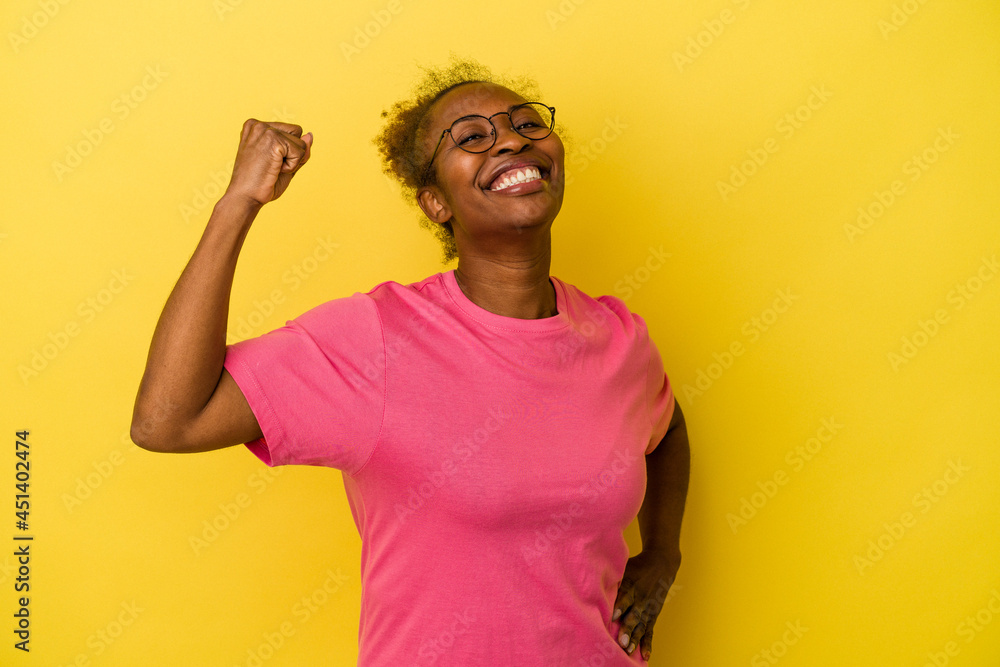Young african american woman isolated on yellow background cheering carefree and excited. Victory concept. Young african american woman isolated on yellow background cheering carefree and excited. Victory concept.