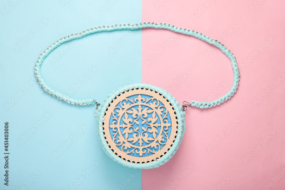 Hand made fashionable handbag on a blue pink pastel background. Top view. Flat lay Hand made fashionable handbag on a blue pink pastel background. Top view. Flat lay