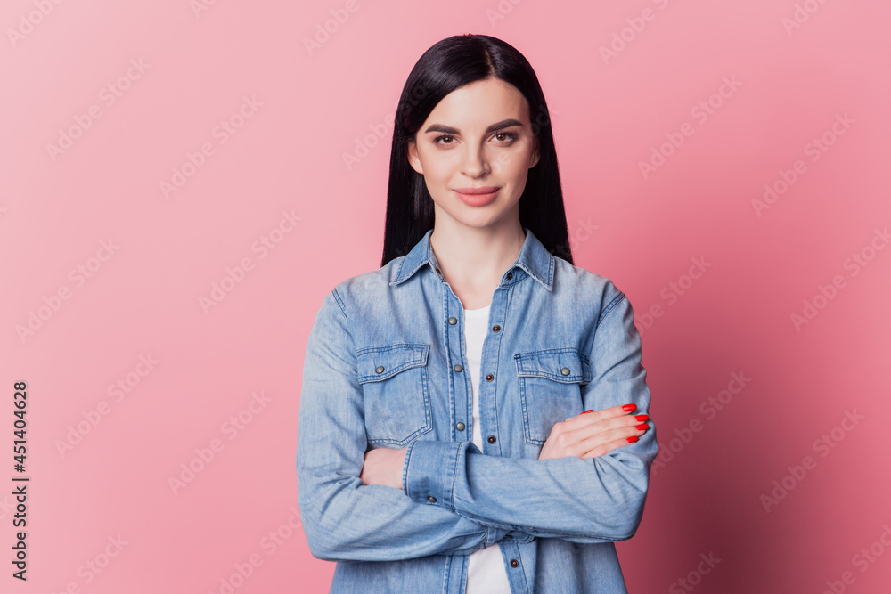 Close-up portrait of yong woman happy positive smile confident crossed hands isolated over pink color background Close-up portrait of yong woman happy positive smile confident crossed hands isolated over pink color background