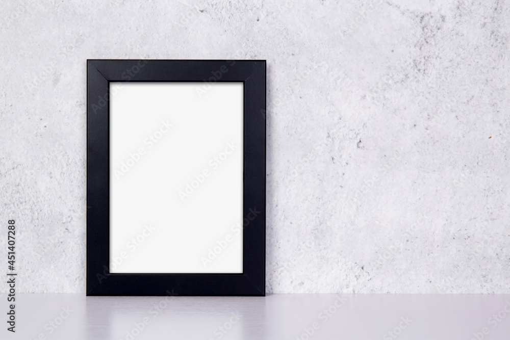 Mockup black frame vertical on table top and wall at home, mock up poster for presentation on desk, your design for gallery photo and picture image, border template and decoration for advertising. Mockup black frame vertical on table top and wall at home, mock up poster for presentation on desk, your design for gallery photo and picture image, border template and decoration for advertising.