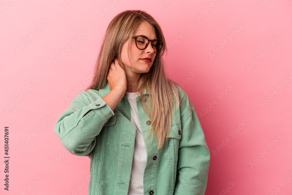 Young russian woman isolated on pink background having a neck pain due to stress, massaging and touching it with hand. Young russian woman isolated on pink background having a neck pain due to stress, massaging and touching it with hand.
