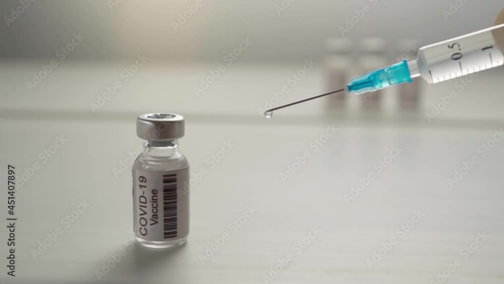 close-up disposable syringe with a drop of liquid medicine on a needle placed against a white background. Vaccination is the most anticipated procedure. Research on the concept of protection against close-up disposable syringe with a drop of liquid medicine on a needle placed against a white background. Vaccination is the most anticipated procedure. Research on the concept of protection against