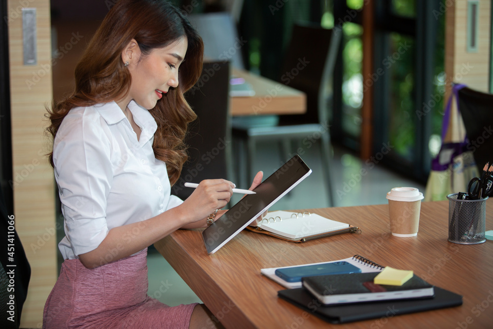 Portrait of Beautiful businesswoman sitting at desk and working with laptop computer. Portrait of Beautiful businesswoman sitting at desk and working with laptop computer.