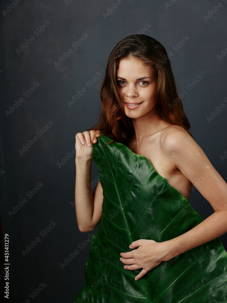 pretty woman with naked body hiding behind palm leaf pretty woman with naked body hiding behind palm leaf