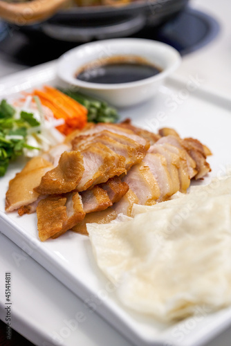 A delicious Chinese dish, grilled meat with noodle sauce and cilantro carrots